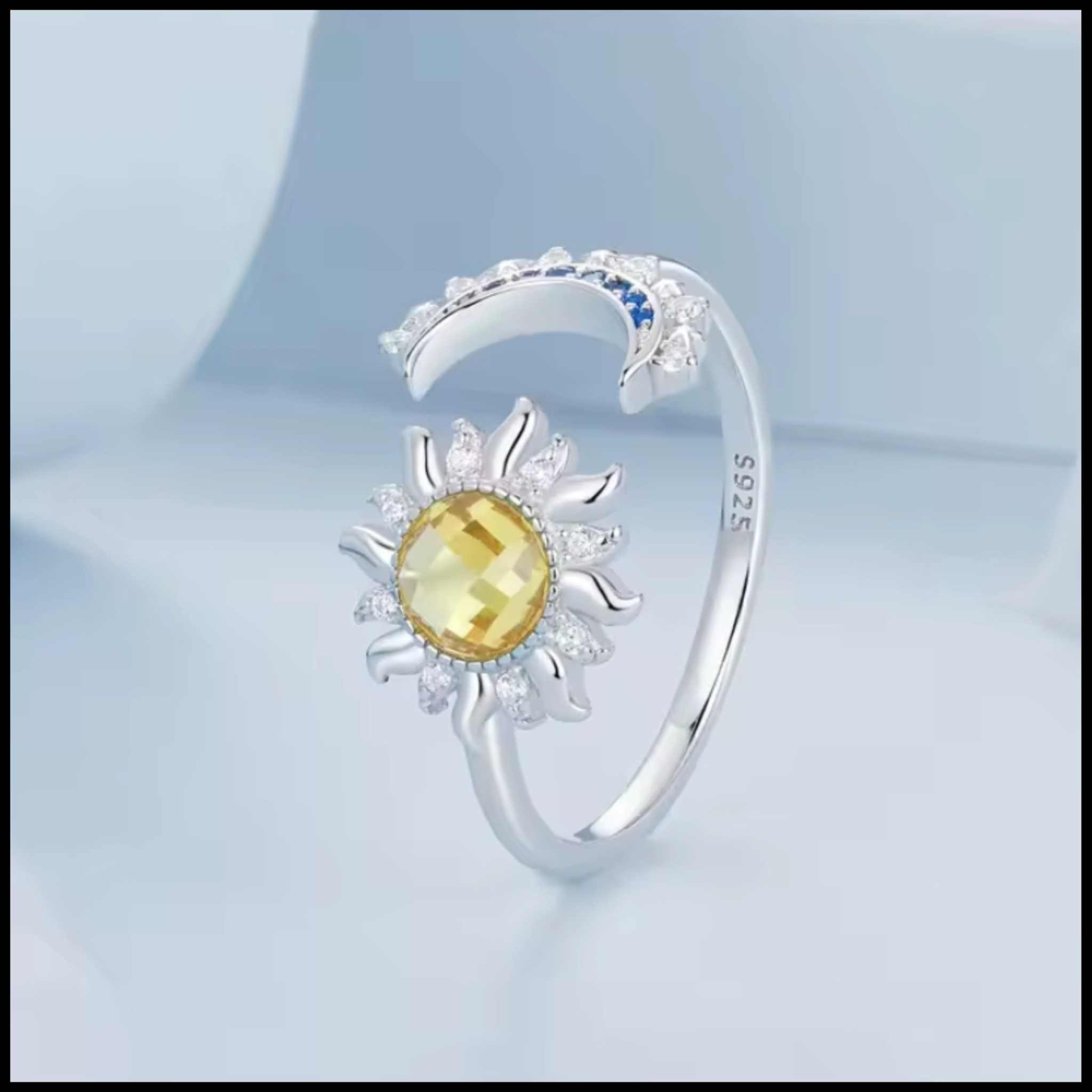 Silver adjustable ring with moon and star design and blue zirconia stones