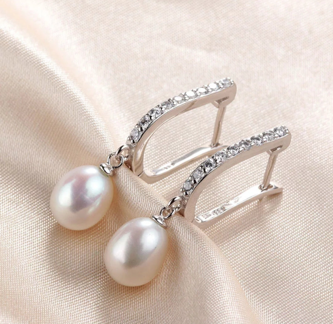 Natural Pearl Silver earrings with drop pearls and zirconia set in sterling silver on satin background
