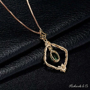 18K yellow gold Diamonds & Tsavorite pendant with oval green tsavorite garnet and surrounding sparkling diamonds on a chain