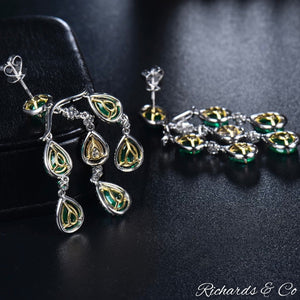 High end luxury long drop earrings with natural emeralds and flawless diamonds in 18K white gold