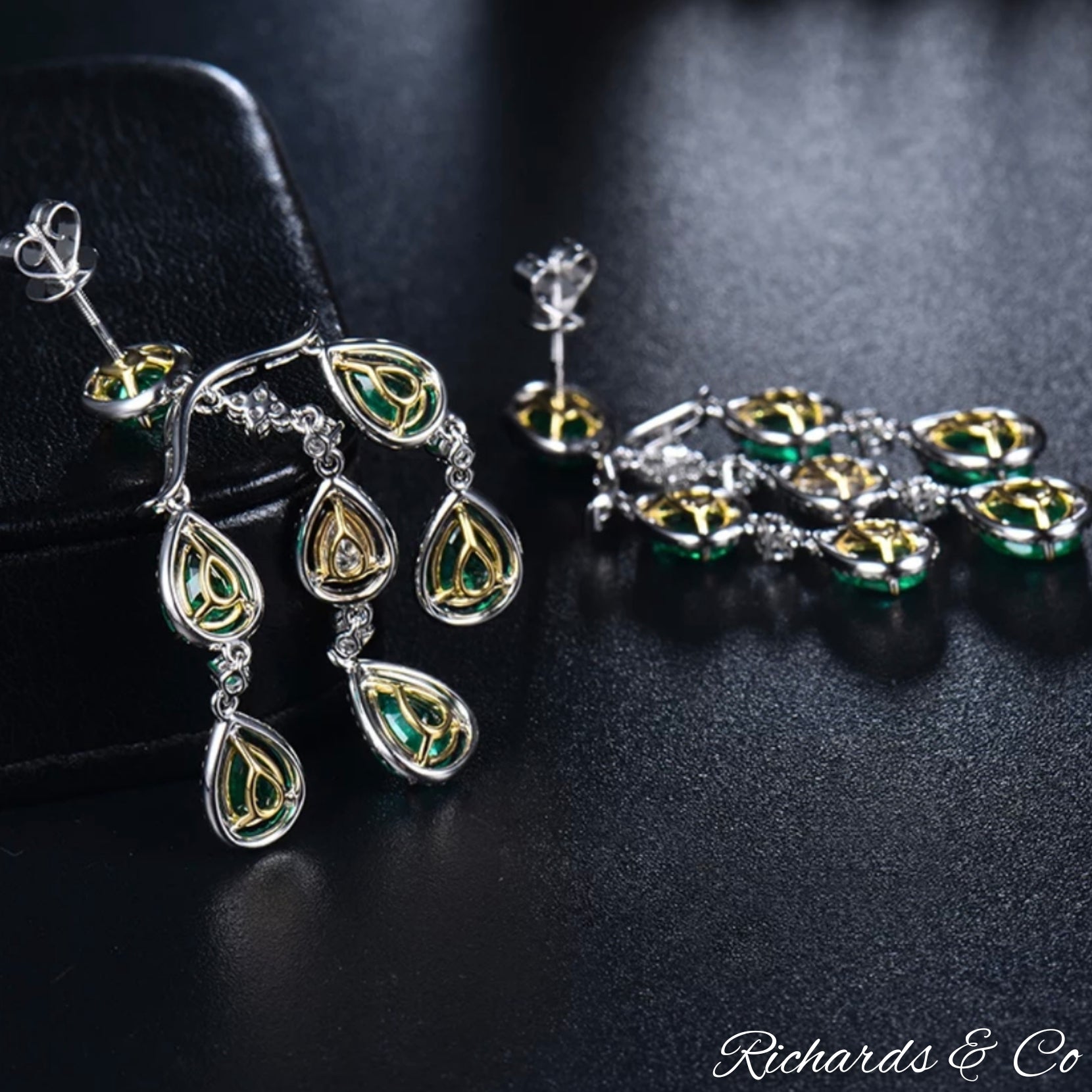 High end luxury long drop earrings with natural emeralds and flawless diamonds in 18K white gold