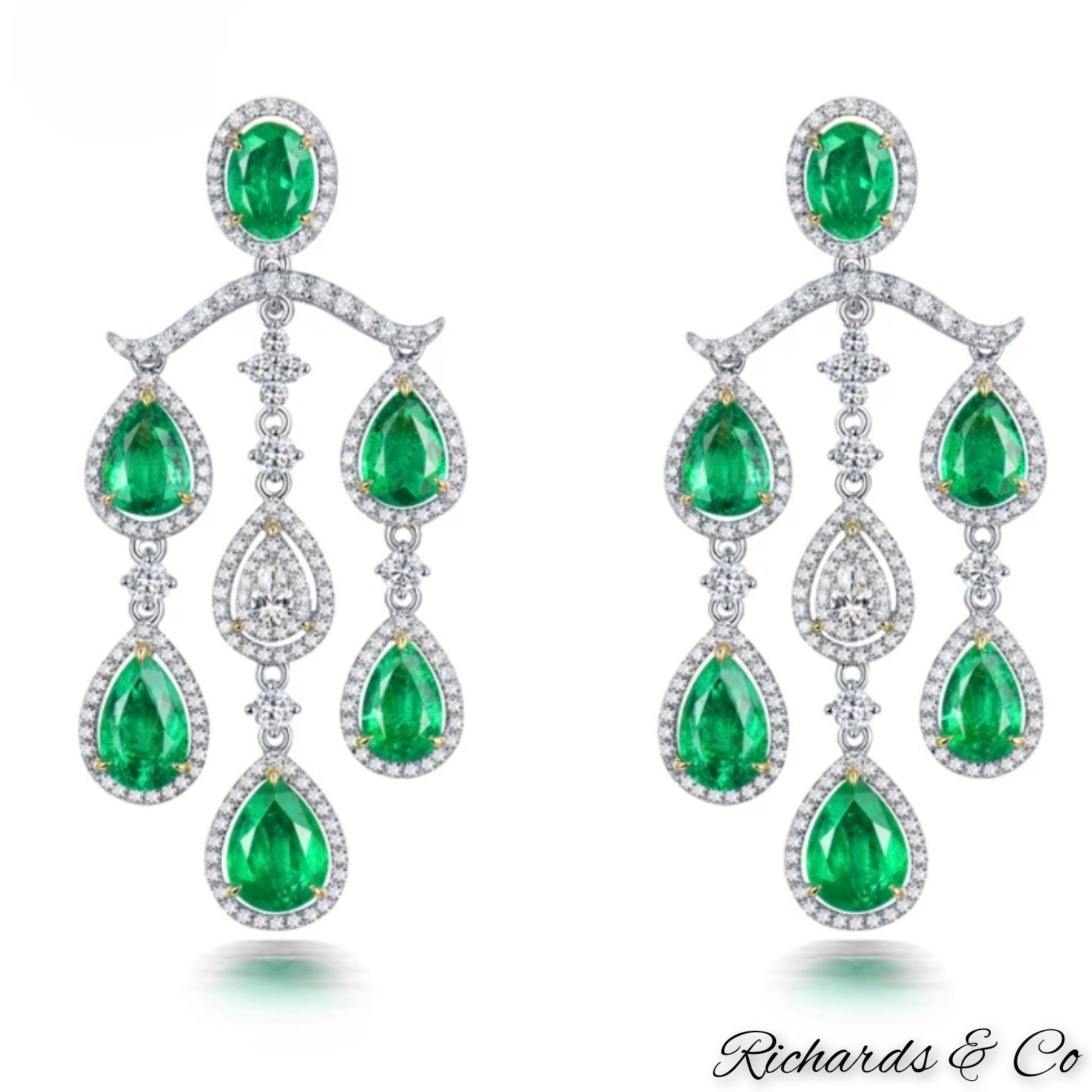 High end luxury earrings with natural emeralds and diamonds in solid 18K white gold chandelier design