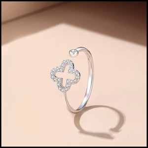 Adjustable four-leaf clover ring in silver with sparkling cubic zirconia stones, symbolizing luck and elegance