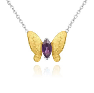 A butterfly-shaped pendant necklace featuring textured gold wings butterfly, a central faceted purple gemstone, and a silver-toned chain on a white background.