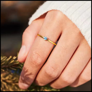 R&C Minimalistic Blue Heart Gold Ring with blue zirconia heart stone on hand