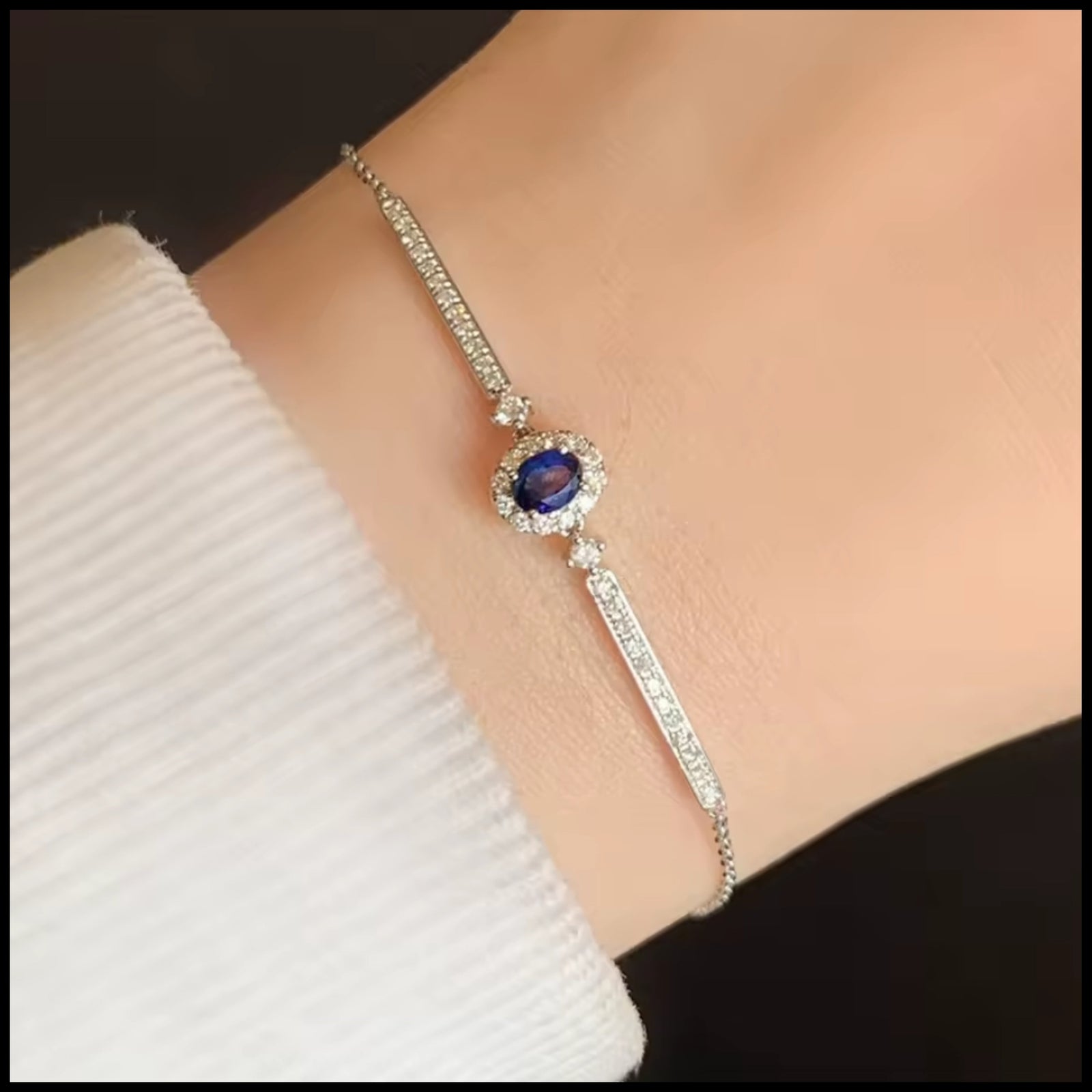 Delicate 18k white gold sapphire and diamond bracelet on wrist