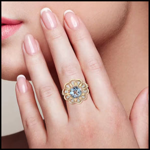 Flower Blue Topaz & Diamond Ring in 14k yellow gold, featuring a 2.61ct sky blue topaz and 20 natural diamonds worn on hand