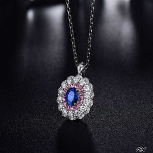 Meghan Sapphire & Diamonds 18K white gold pendant with oval blue sapphire surrounded by pink sapphires and round diamonds