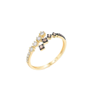 Gold ring with embedded stones on a light blue and white background