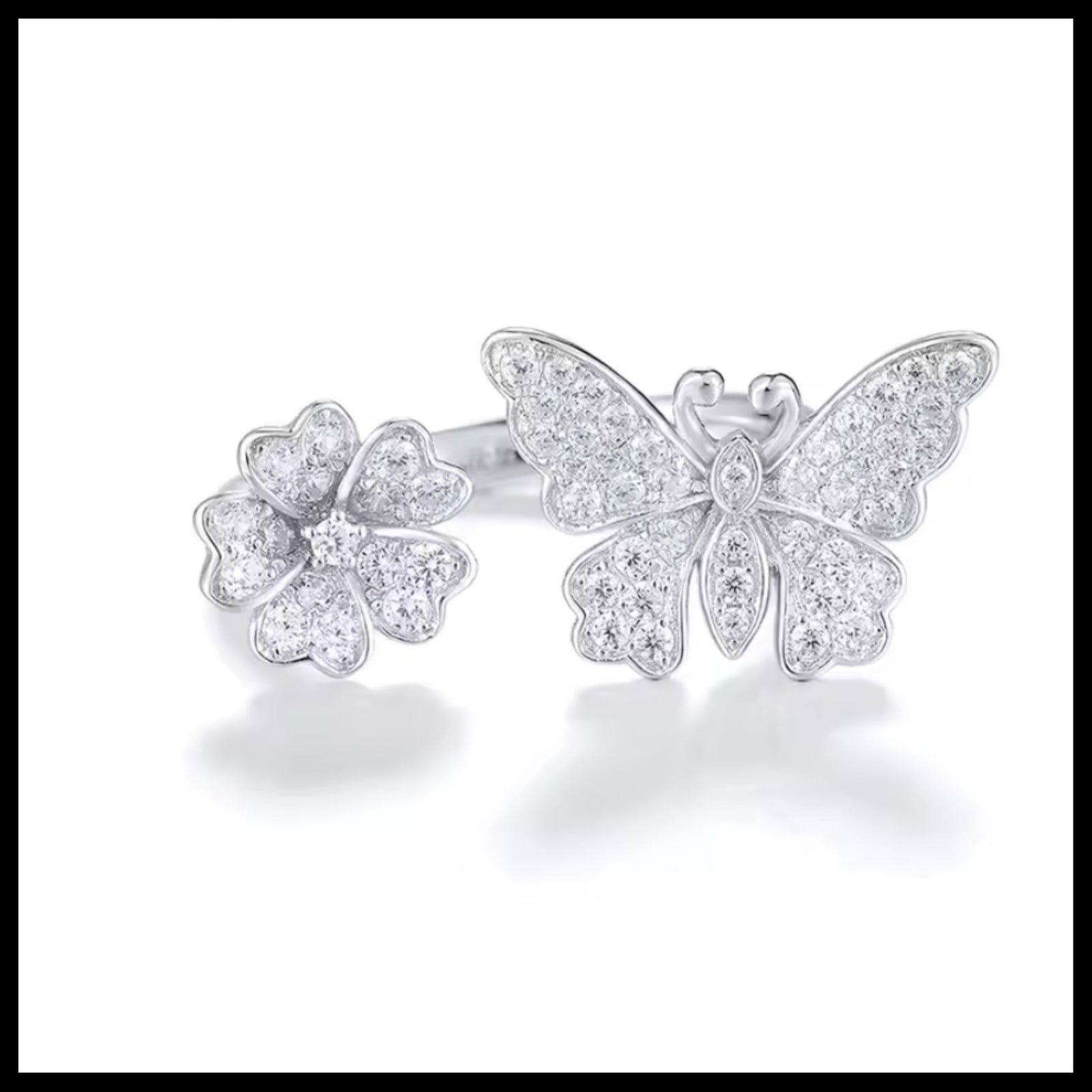 Butterfly and flower-shaped silver ring on a white background
