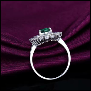 Emerald and diamond ring in 18k white gold with pear-cut emerald and round and baguette diamonds from Clarity Collection