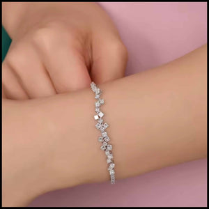 Diamond  bracelet with diamonds on a person's wrist against a pink background