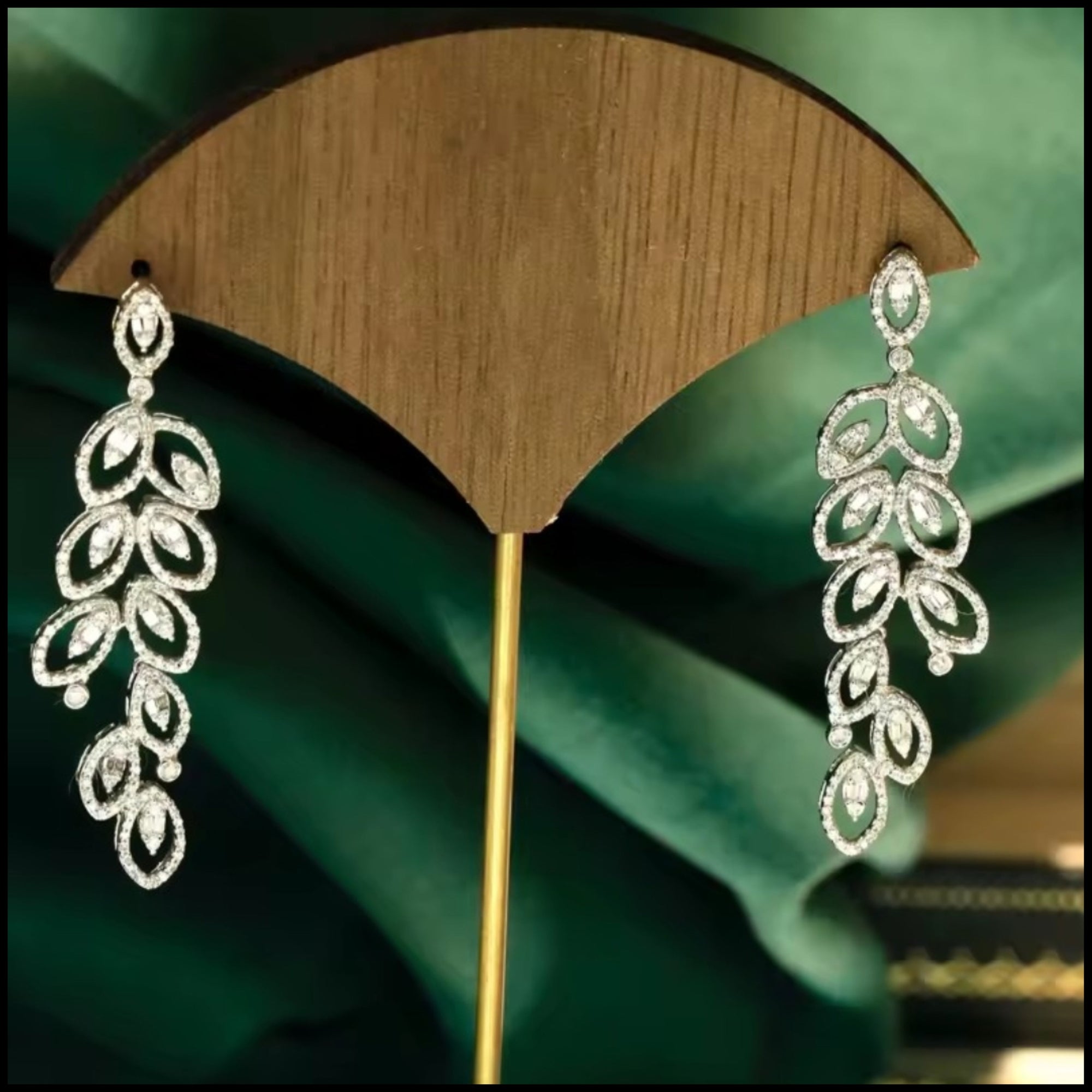Elegant diamond long drop earrings in 18k white gold with a leaf-inspired design and sparkling natural diamonds