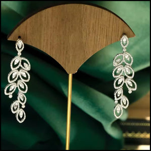 Elegant diamond long drop earrings in 18k white gold with a leaf-inspired design and sparkling natural diamonds