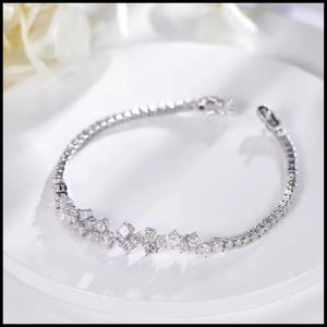  bracelet with clear diamond stones on a white fabric background