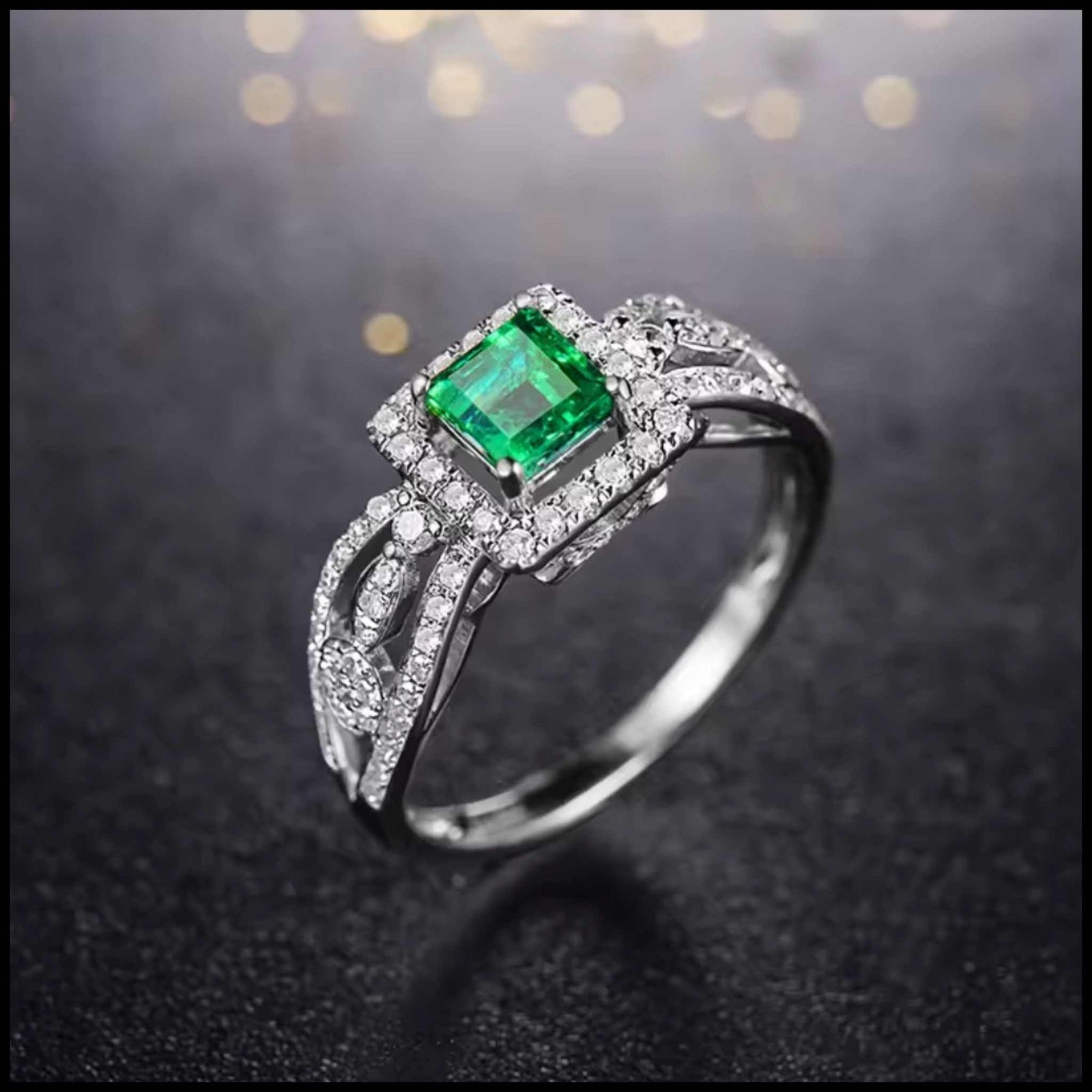 Emerald ring with diamonds on a dark background