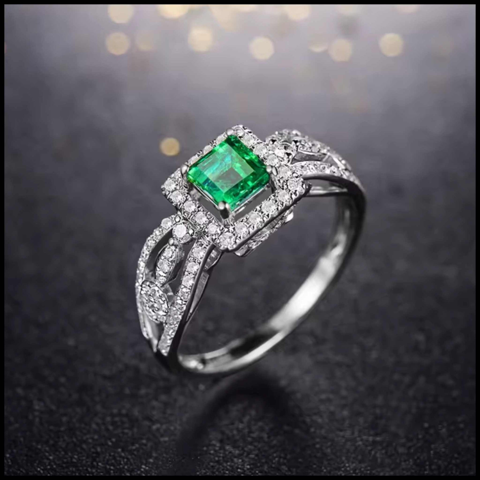 Emerald ring with diamonds on a dark background