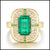 Gold ring with a green emerald gemstone and smaller diamonds on a white background