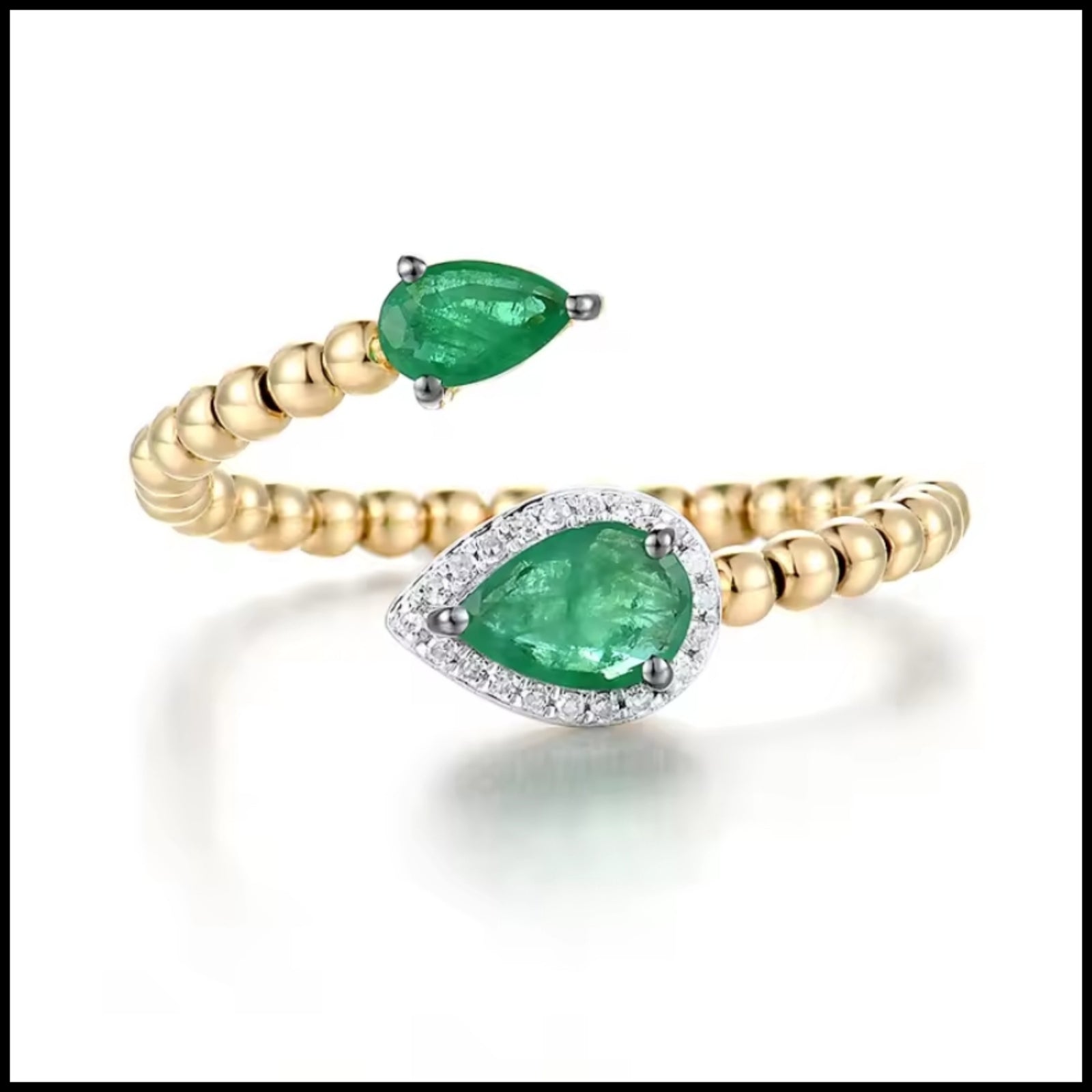 Gold ring with green emerald gemstones on a white background