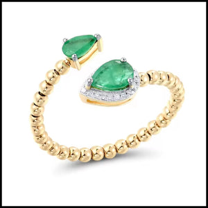 Gold ring with green emerald gemstones on a white background
