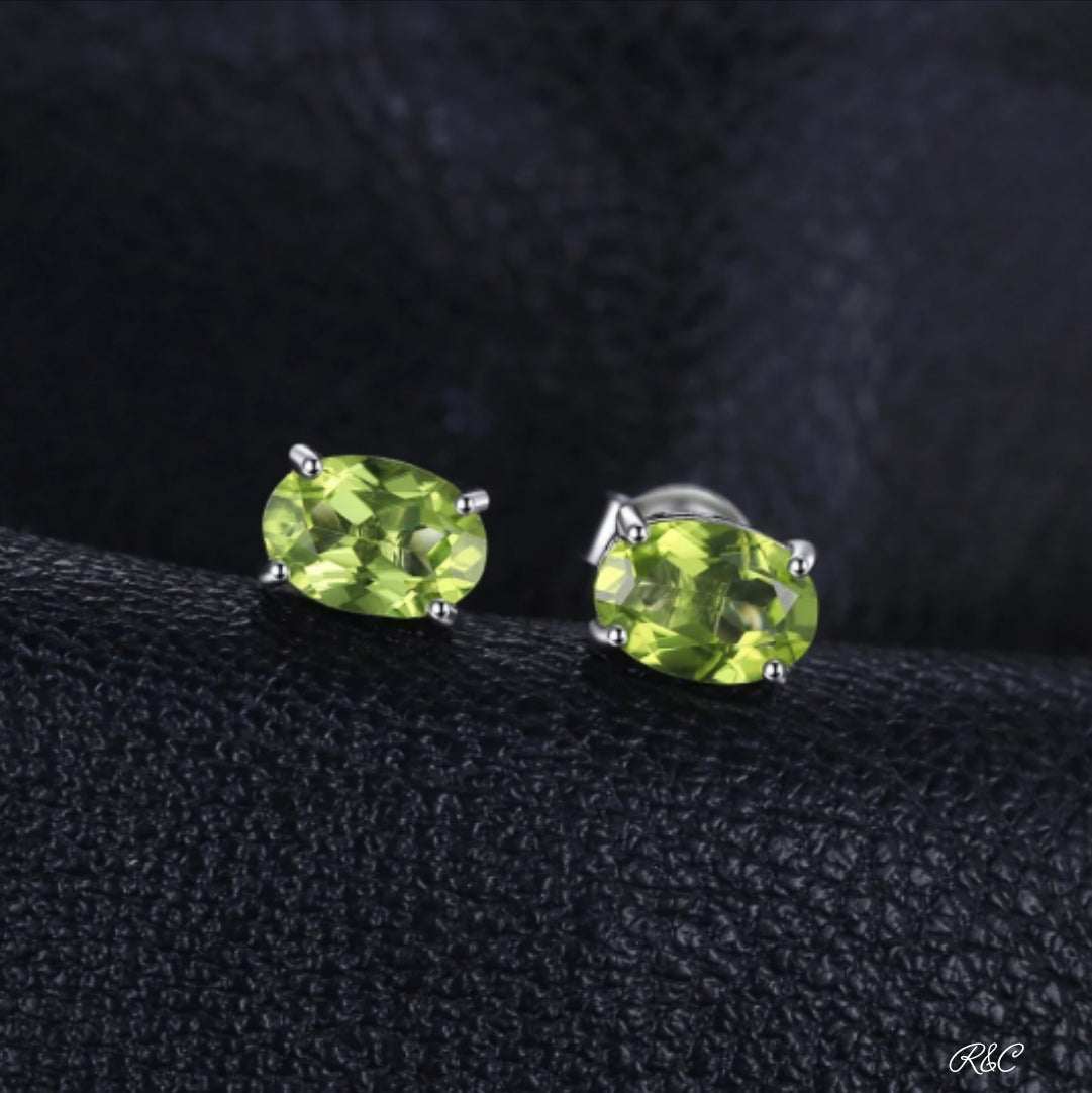 Oval natural peridot stud earrings in sterling silver with vibrant green VVS grade stones
