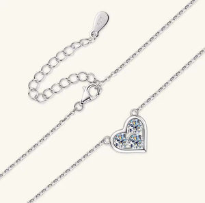 Silver necklace with a heart-shaped pendant on a white background