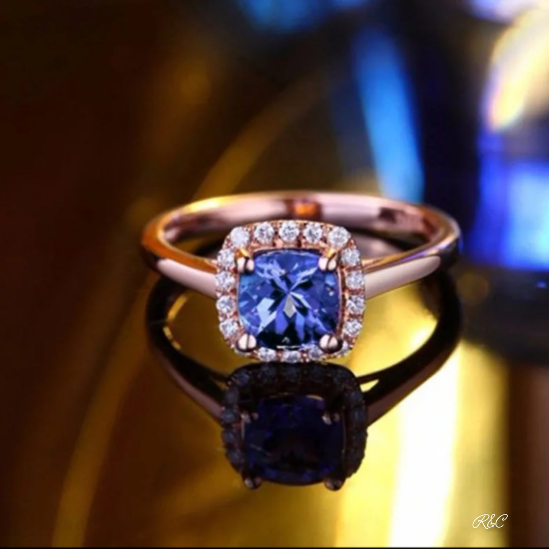 18K rose gold tanzanite and diamond ring with vibrant blue-violet stone and halo setting