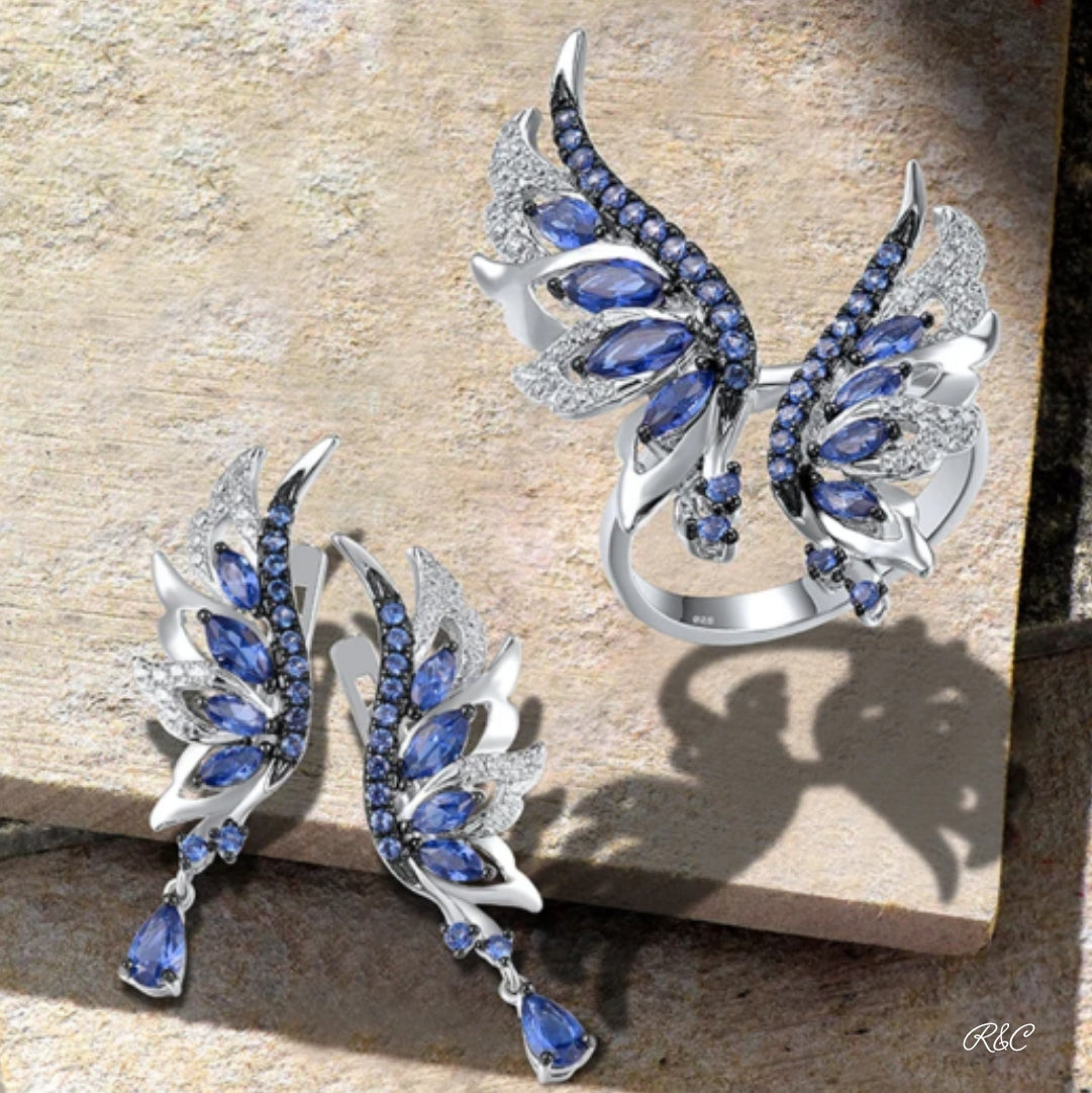 HONOUR Angel Wing Earrings and Ring set with blue and white cubic zirconia in silver, inspired by angel wings.