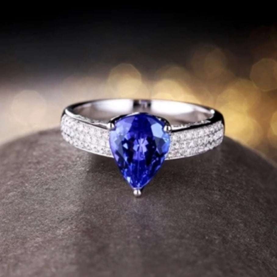 Amelia ring with pear-shaped blue tanzanite and diamond accents set in 18K white gold elegant design