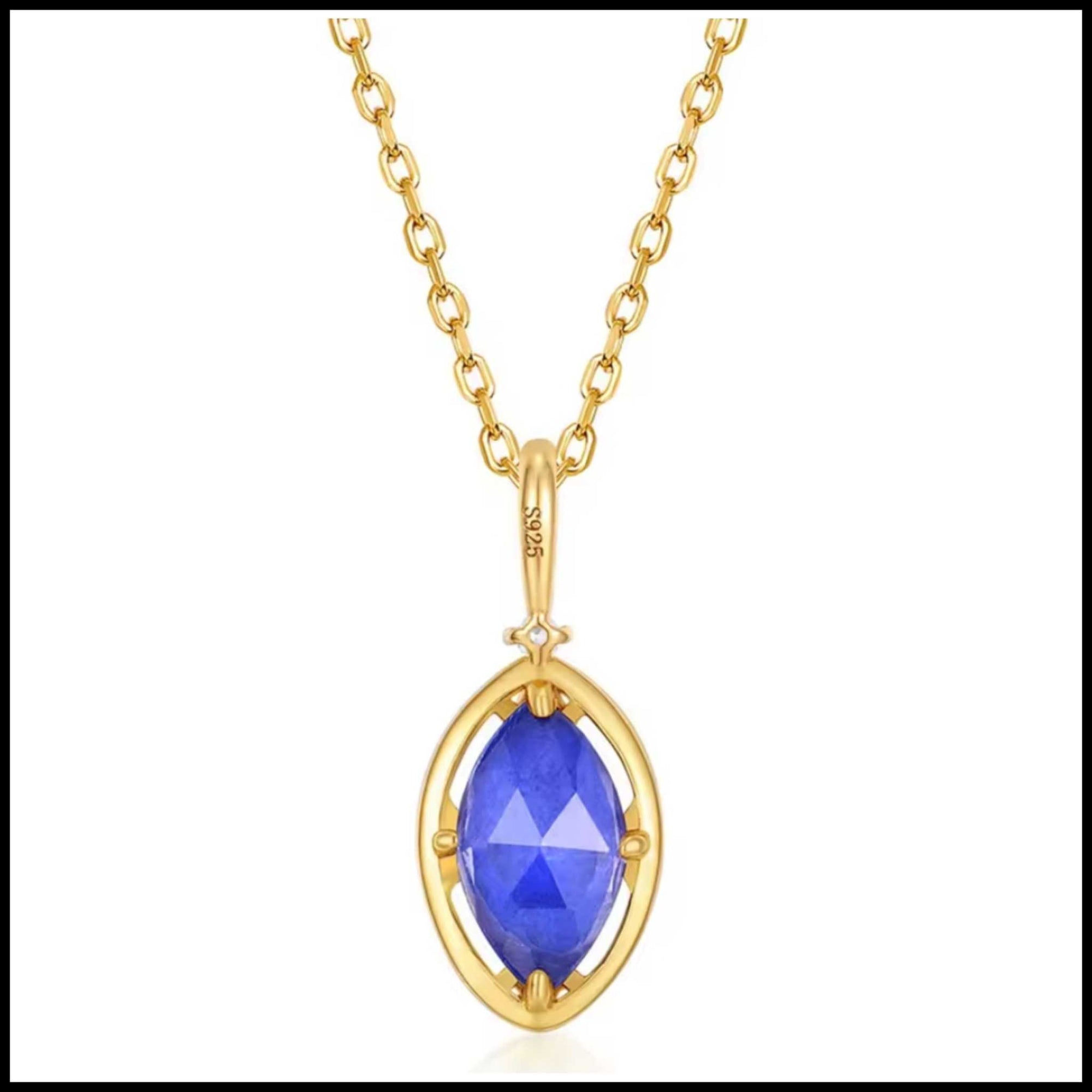 Gold necklace with a blue gemstone pendant on a white background