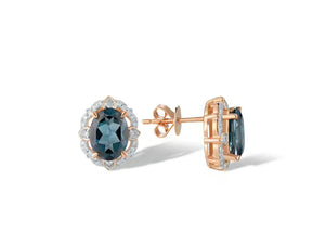 A pair of rose gold stud earrings featuring oval-cut dark blue topaz gemstones surrounded by small clear diamond stones, shown on a clean white background.