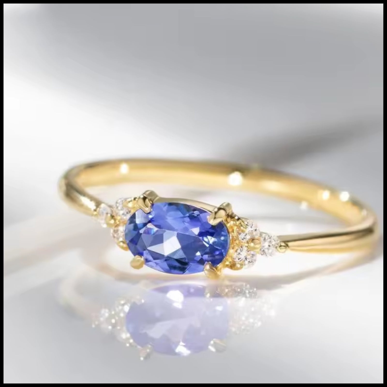 Blue oval stone ring with gold-plated band and side diamonds in elegant vintage design