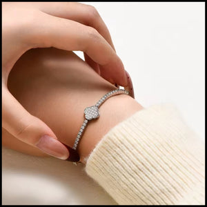 Close-up of a hand wearing a silver Moissanite Tennis Bracelet with sparkling VVS1 D Colour Grade stones