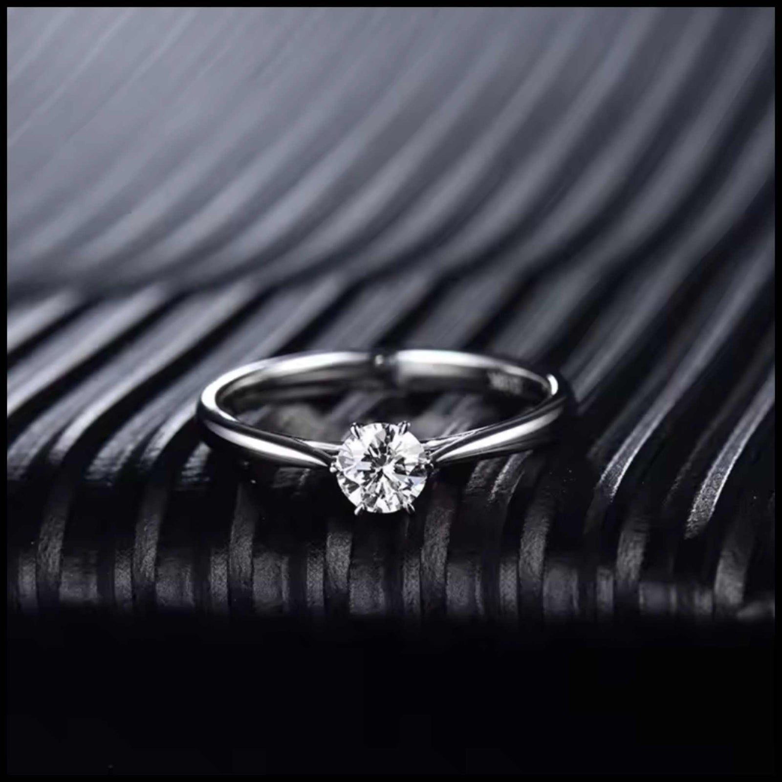 Diamond ring on a textured black surface