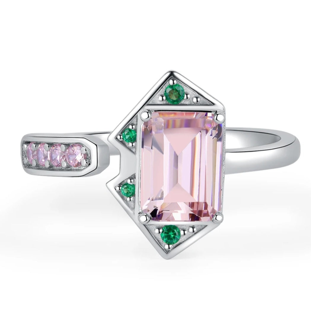 A silver ring featuring a pink and green emerald cut design, part of the MONICA Pink Ring COLLECTION.