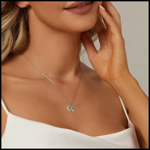 Woman wearing Moon & Star Silver Necklace with blue zirconia stones on white top