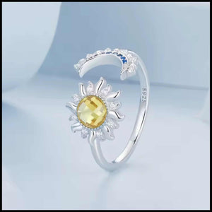 Silver adjustable ring with moon and star design and blue zirconia stones