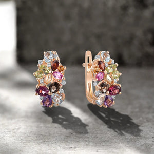 A pair of rose gold multi-gem and diamond earrings with a vibrant mix of colored gemstones and sparkling diamonds.
