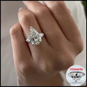 Diamond ring on a hand with a 'Moissanite' label in the corner