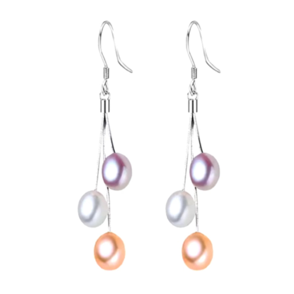 A pair of silver hoop earrings with multi-colored pearl drops.