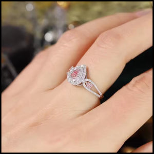 white gold  ring with a pink gemstone on a hand