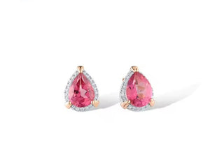 A pair of pear-shaped stud earrings featuring vibrant pink topaz gemstones in a gold setting, surrounded by a halo of small clear natural diamond stones, shown on a clean white background.