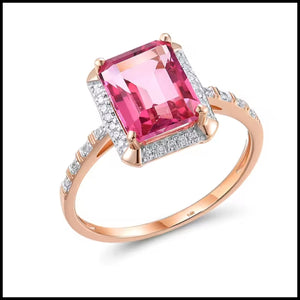 Rose gold ring with a pink gemstone and diamond accents on a white background