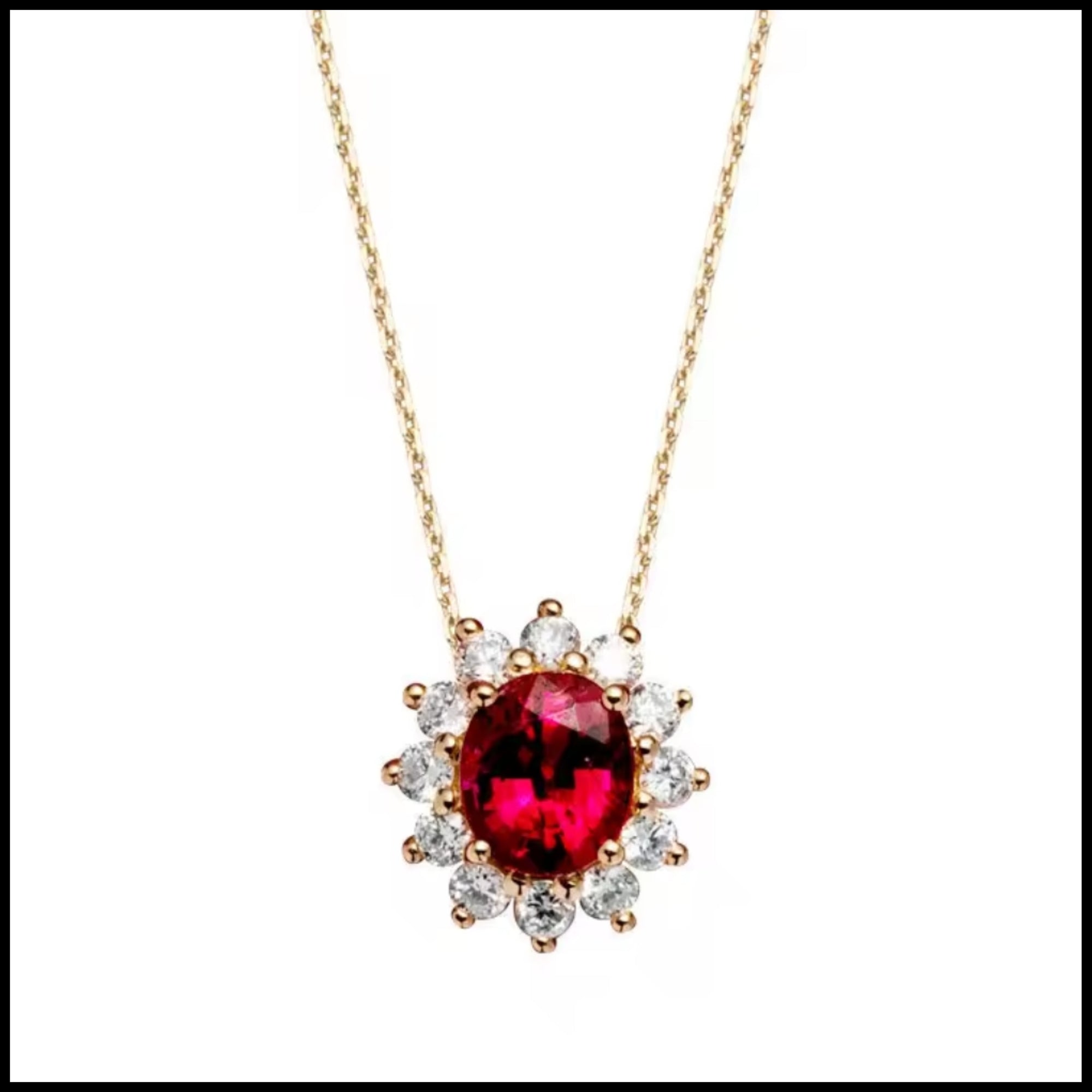 Gold necklace with a red gemstone pendant on a white background
