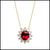 Gold necklace with a red gemstone pendant on a white background