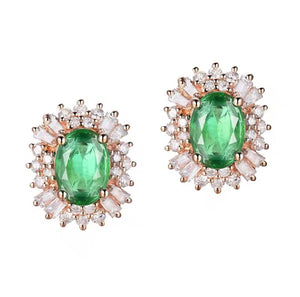 A pair of rose gold stud earrings featuring oval-cut green emerald-cut gemstones surrounded by round and baguette-cut clear diamonds, set against a plain white background.