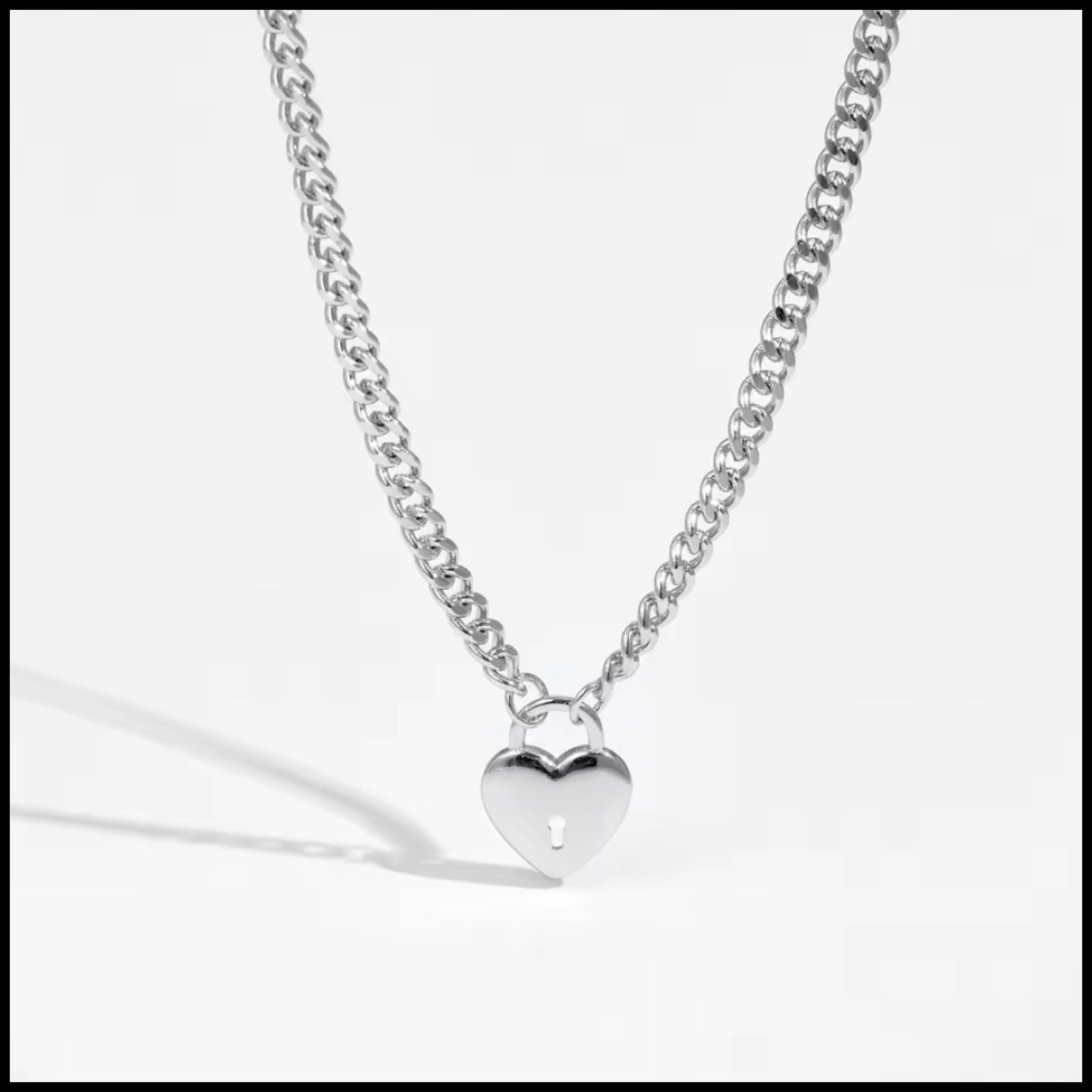 Silver heart-shaped pendant necklace on a white background