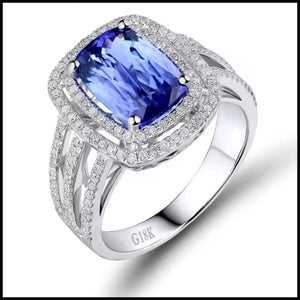 White Gold ring with a blue gemstone and diamond accents on a white background