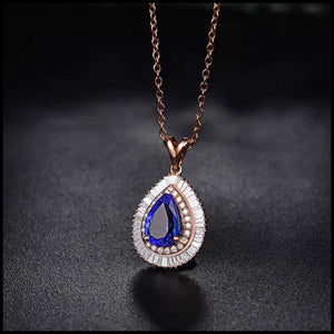 Tanzanite diamond rose gold necklace with pear-shaped blue tanzanite and surrounding diamonds