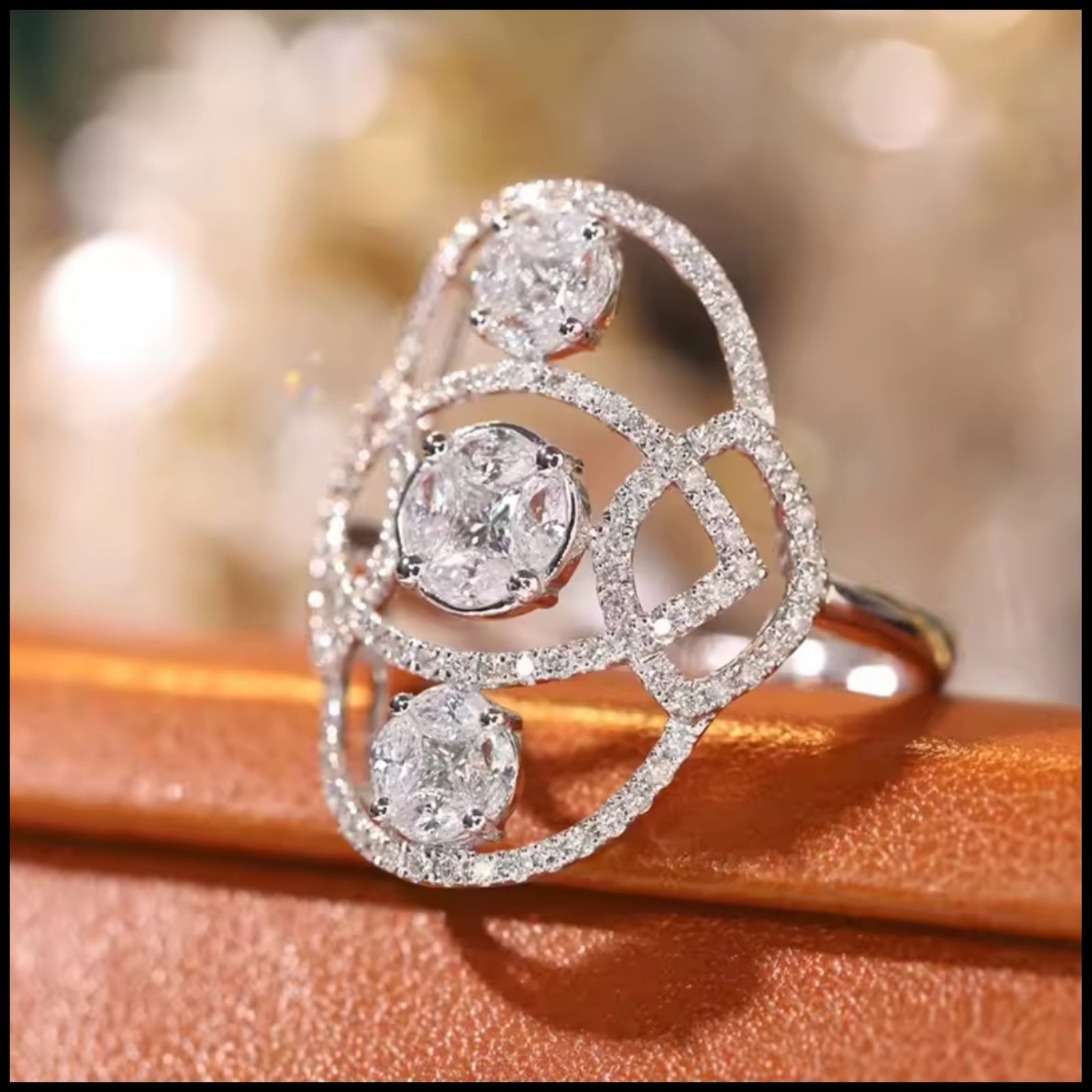 Diamond ring with three main diamonds on a wooden surface